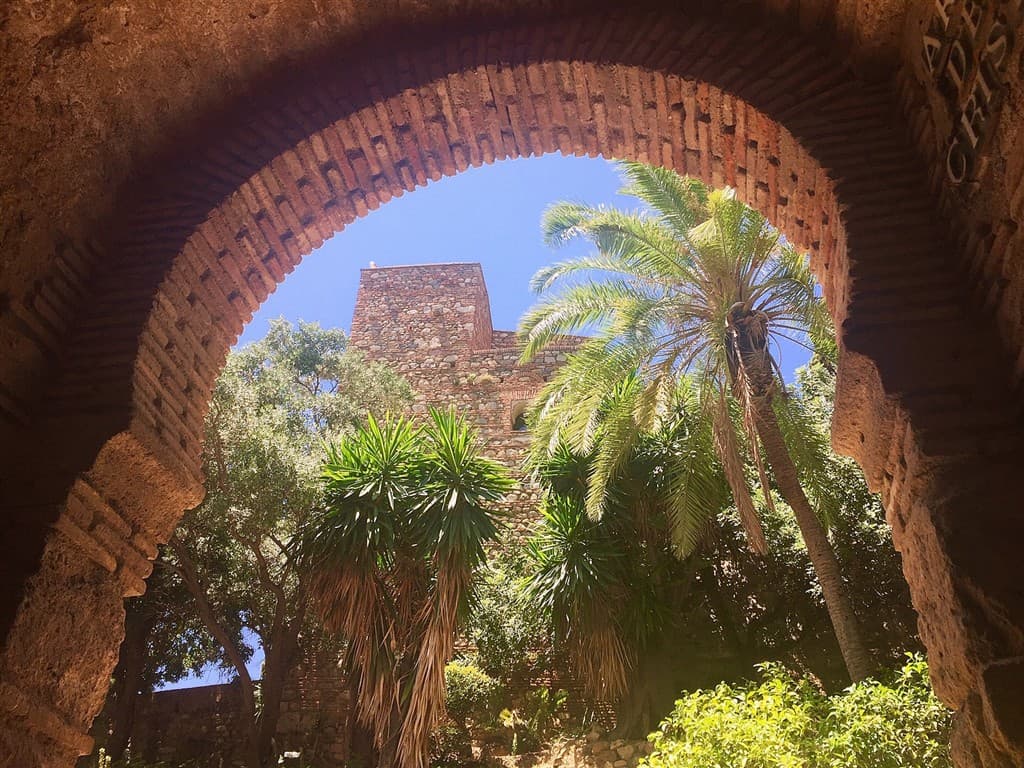 Brána do pevnosti Alcazaba so stromami v Malage.