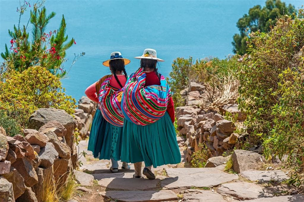 Tradičné peruánske ženy (Cholitas) v dlhých sukniach a klobúkoch v meste Puno na brehu jazera Titicaca